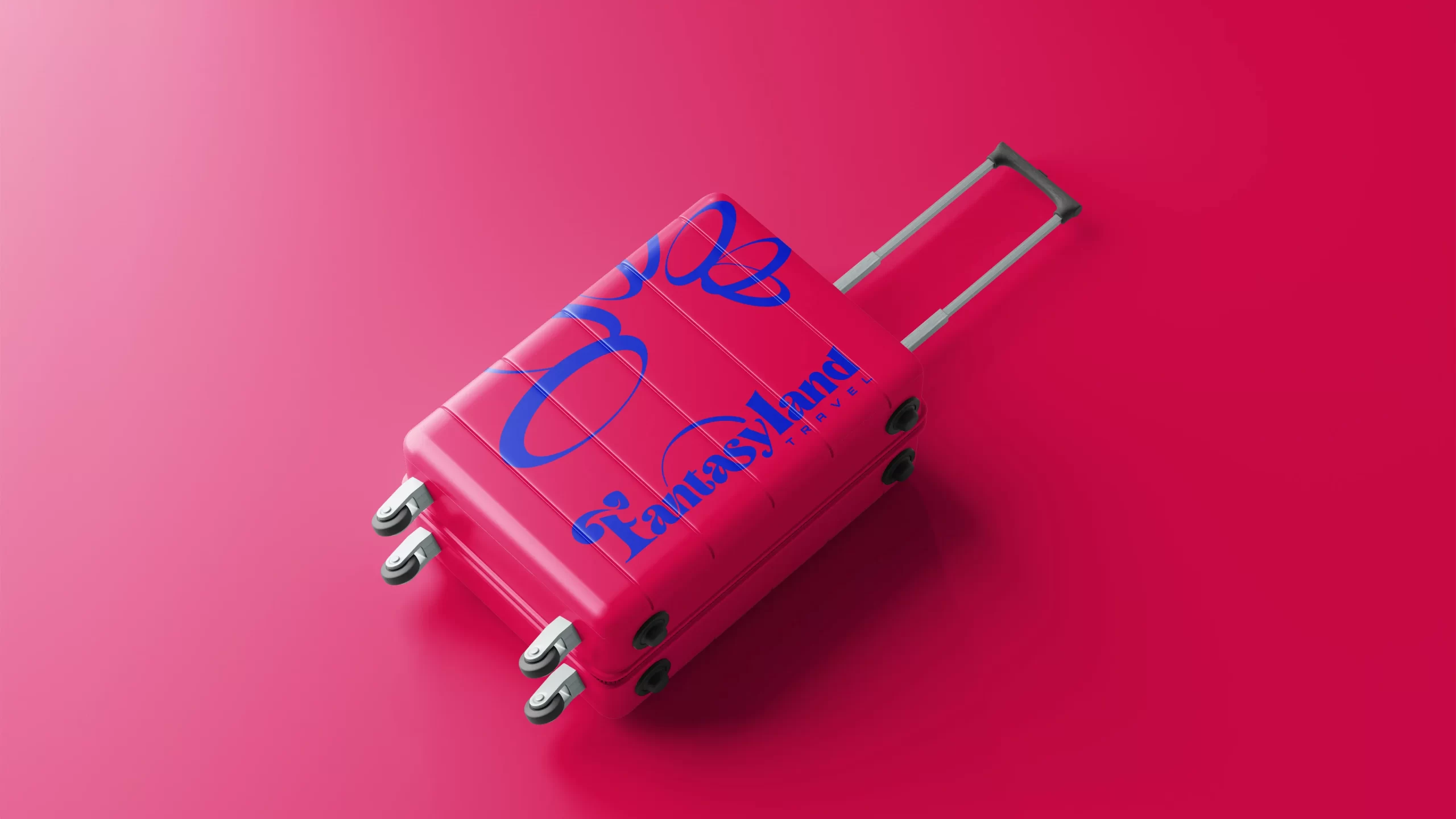 mala de viagem rosa com logotipo da Fantasyland Travel em azul em um fundo rosa